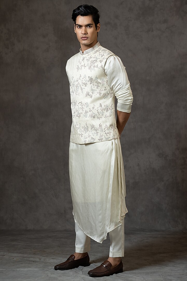 Ivory Linen Satin Cutdana Embroidered Asymmetric Bundi Jacket by PAARSH at Pernia's Pop Up Shop