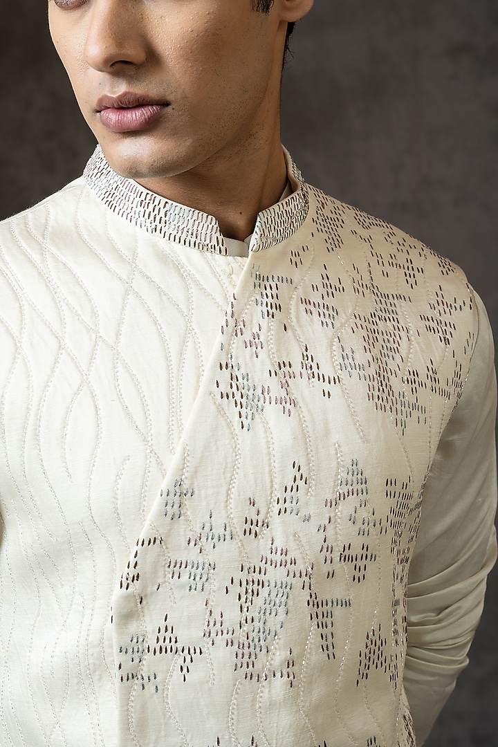 Ivory Linen Satin Cutdana Embroidered Bundi Jacket Set by PAARSH at Pernia's Pop Up Shop