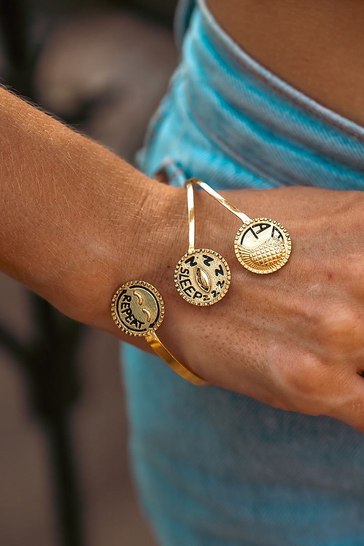 Gold Plated Eat Sleep Repeat Handcuff by PARISHRI at Pernia's Pop Up Shop