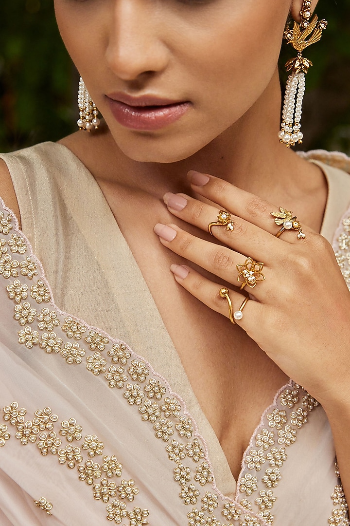 Antique Gold Finish Stackable Floral Ring (Set Of 4) by PARISHRI at Pernia's Pop Up Shop