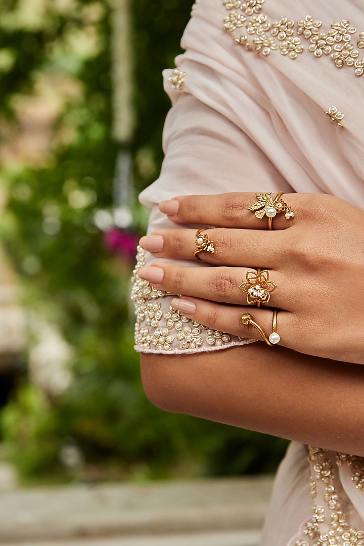 Antique Gold Finish Stackable Floral Ring (Set Of 4) by PARISHRI at Pernia's Pop Up Shop