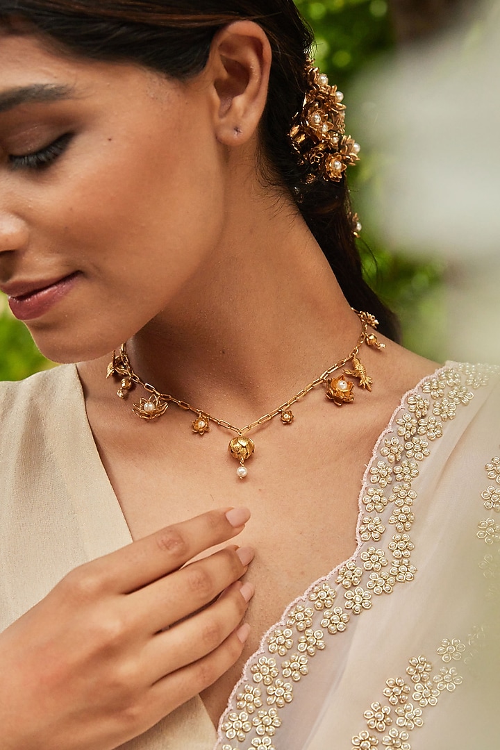 Antique Gold Finish Bird & Lotus Charm Necklace by PARISHRI at Pernia's Pop Up Shop