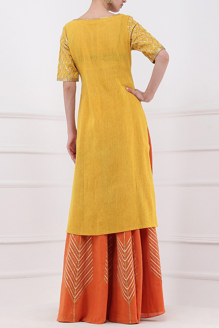 Orange gota patti embroidered lehenga and mustard kurta set available only at Pernia's Pop Up Shop.