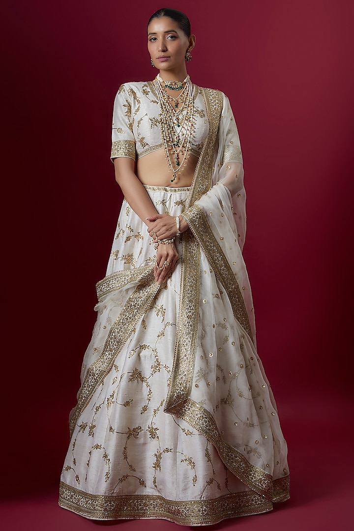 Off-White Raw Silk Embroidered Bridal Lehenga Set by Pooja & Keyur at Pernia's Pop Up Shop