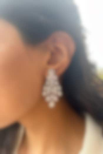 White Finish Fancy-Cut Cubic Zirconia Dangler Earrings In Sterling Silver by PRATA at Pernia's Pop Up Shop