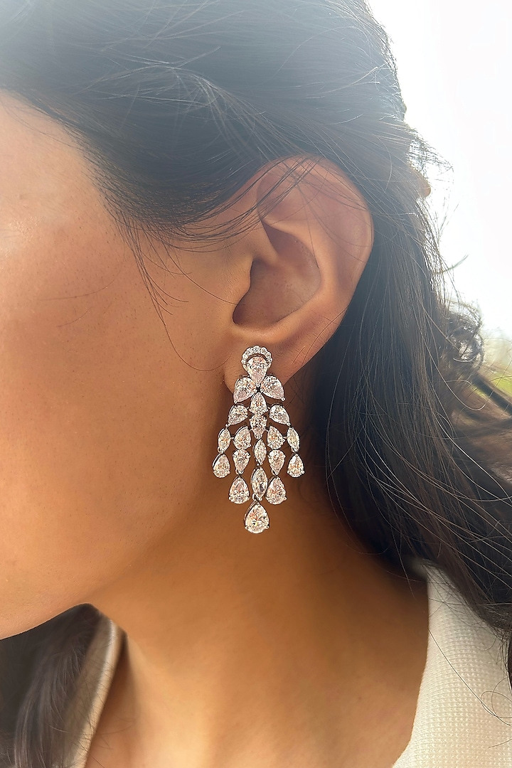 White Finish Fancy-Cut Cubic Zirconia Dangler Earrings In Sterling Silver by PRATA at Pernia's Pop Up Shop