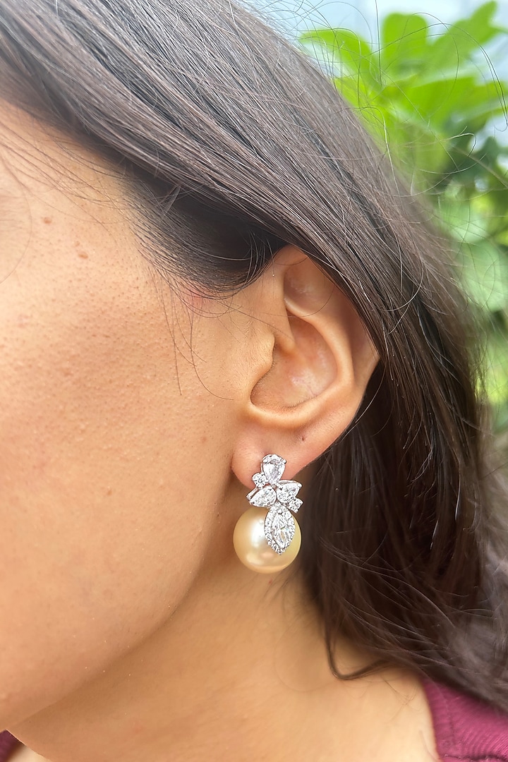 White Finish Fancy-Cut Cubic Zirconia & Round Pearl Floral Stud Earrings In Sterling Silver by PRATA at Pernia's Pop Up Shop