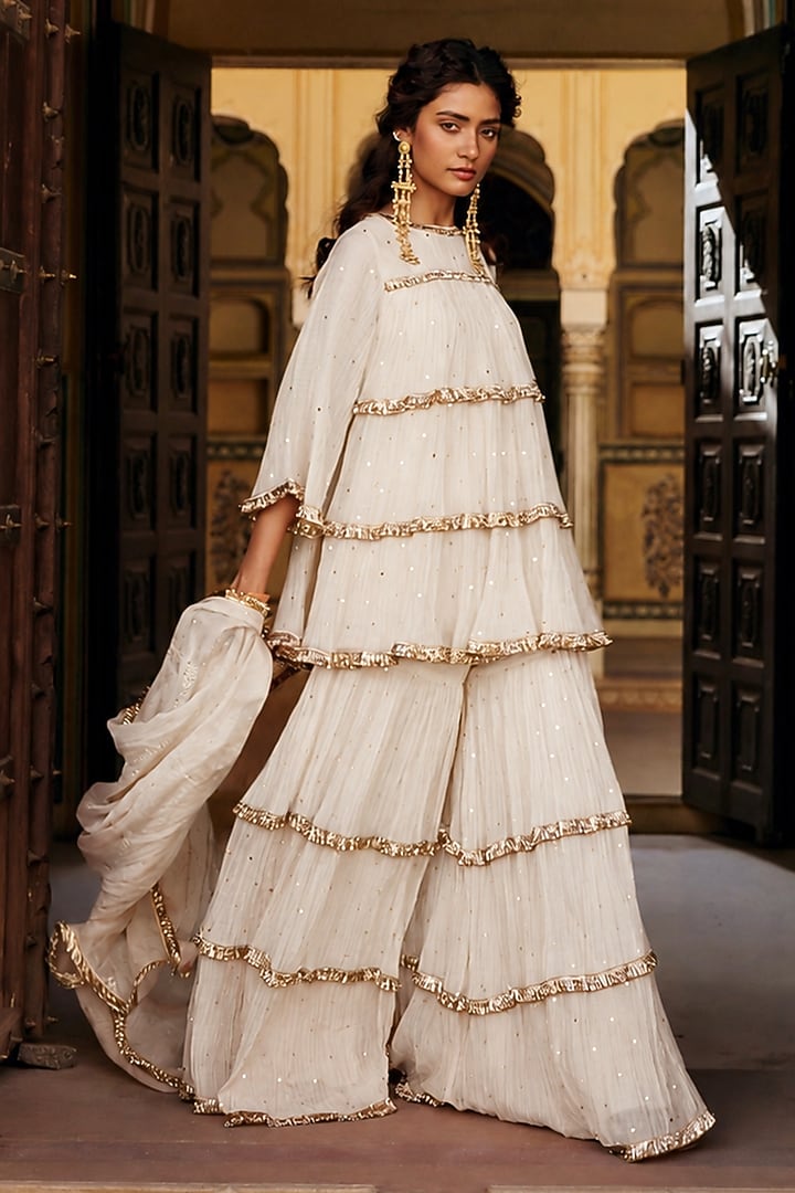 Ivory Chanderi Silk Mukaish Handwork Tiered Party Wear Sharara Set by PREEVIN at Pernia's Pop Up Shop