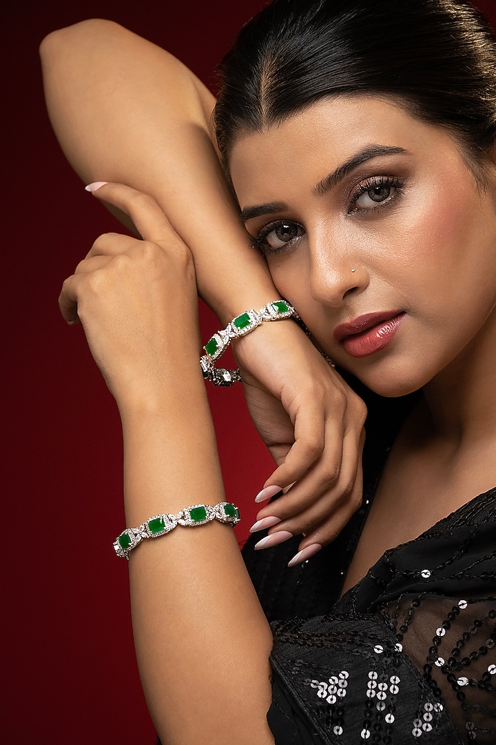 White Finish Cubic Zirconia & Emerald Stone Bangles (Set Of 2) by Prihan Luxury Jewelry at Pernia's Pop Up Shop