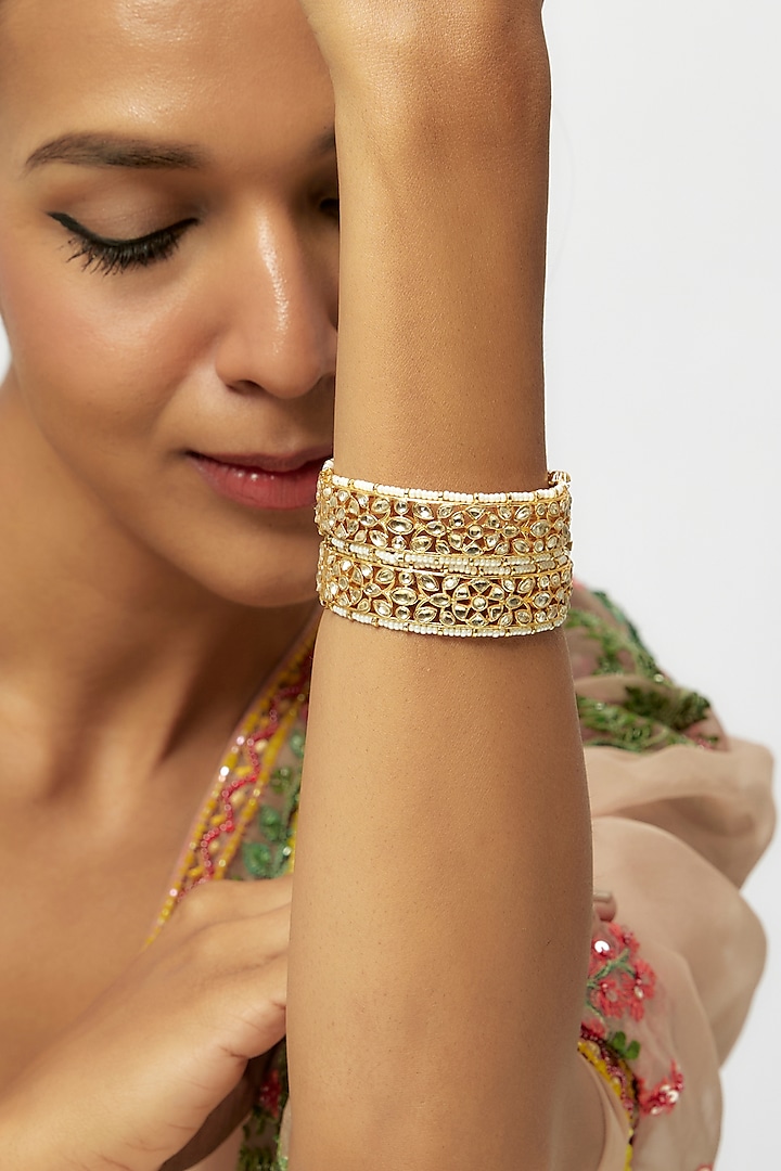 Gold Finish White Kundan Polki Bangles (Set Of 2) by Preeti Mohan at Pernia's Pop Up Shop