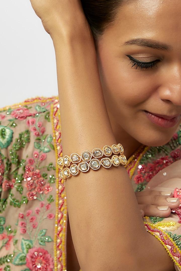 Gold Finish White Kundan Polki Bangles (Set Of 2) by Preeti Mohan at Pernia's Pop Up Shop