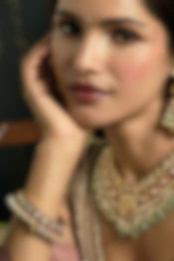 Gold Finish Pink & Green Kundan Polki Bangles (Set Of 2) by Preeti Mohan at Pernia's Pop Up Shop