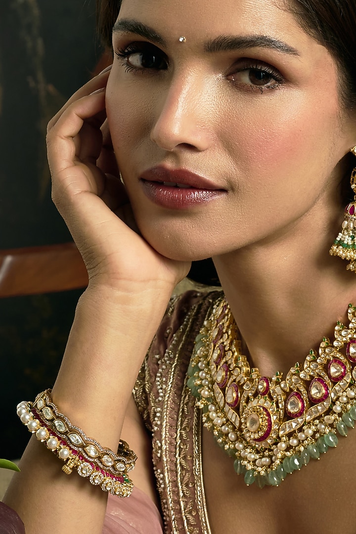 Gold Finish Pink & Green Kundan Polki Bangles (Set Of 2) by Preeti Mohan at Pernia's Pop Up Shop
