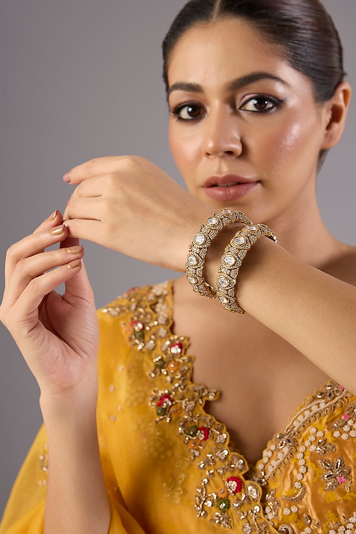 Antique Gold Finish Kundan Polki & Pearl Bangles (Set Of 2) by Preeti Mohan at Pernia's Pop Up Shop