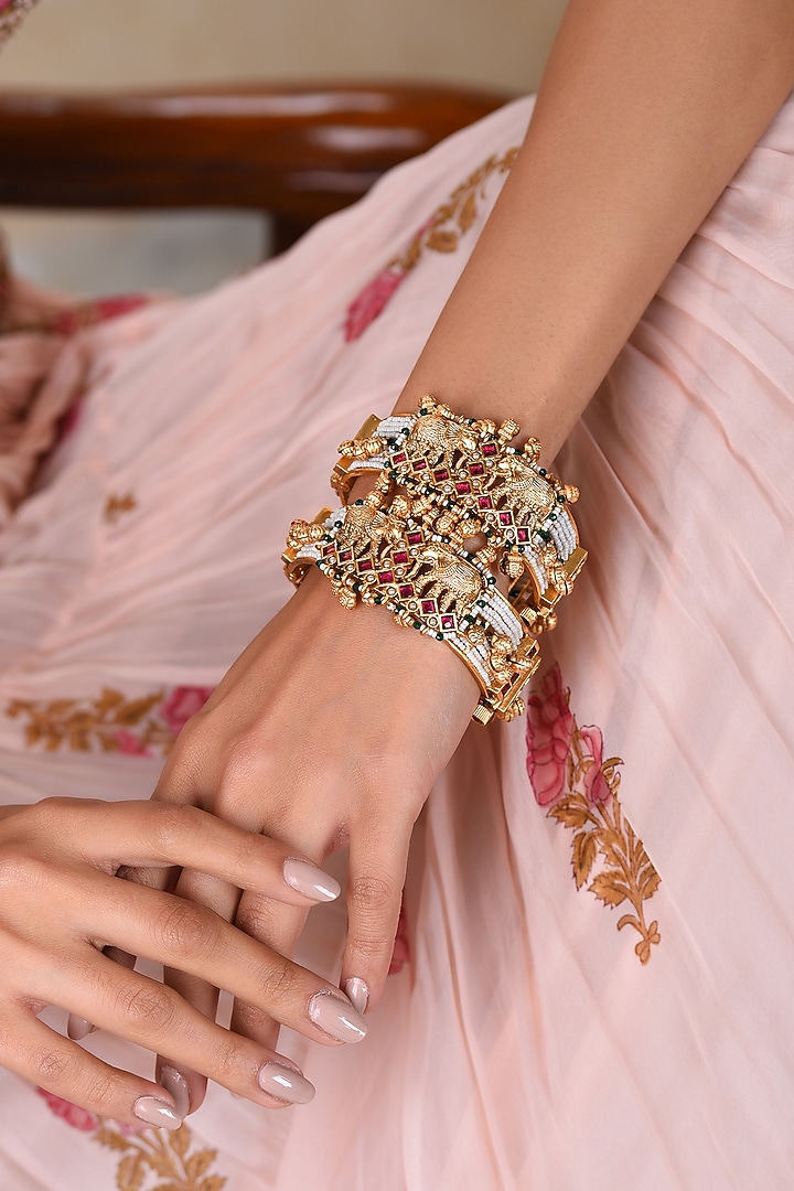 Gold Plated Red & Green Stone Bangles (Set Of 2) by Preeti Mohan at Pernia's Pop Up Shop
