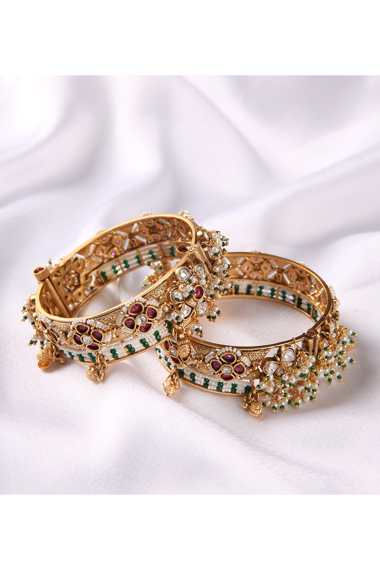 Gold Plated Red & Green Stone Bangles (Set Of 2) by Preeti Mohan at Pernia's Pop Up Shop