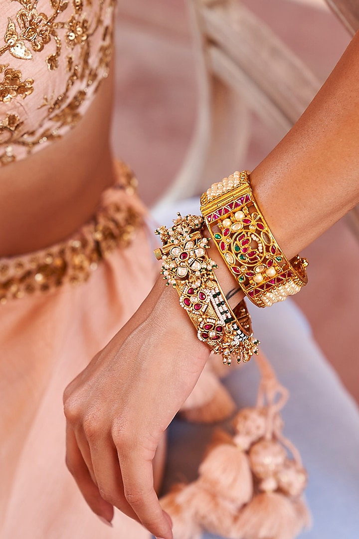 Gold Plated Red & Green Stone Bangles (Set Of 2) by Preeti Mohan at Pernia's Pop Up Shop