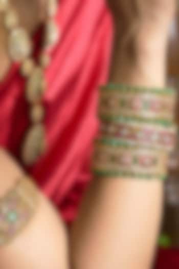 Gold Finish Red & Green Kundan Polki Bangles (Set Of 2) by Preeti Mohan at Pernia's Pop Up Shop