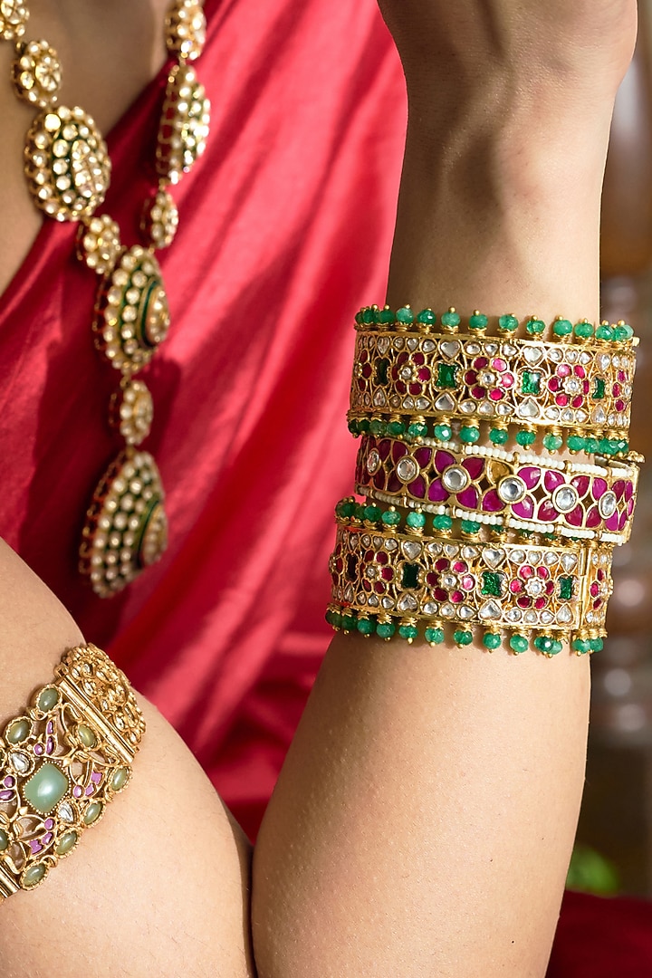 Gold Finish Red & Green Kundan Polki Bangles (Set Of 2) by Preeti Mohan at Pernia's Pop Up Shop