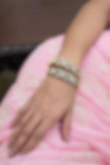 Antique Gold Finish Kundan Polki Bangles (Set Of 2) by Preeti Mohan at Pernia's Pop Up Shop
