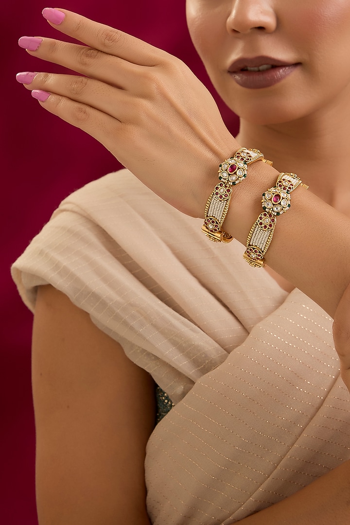 Gold Finish Kundan Polki & Red Stone Bangles (Set Of 2) by Preeti Mohan at Pernia's Pop Up Shop