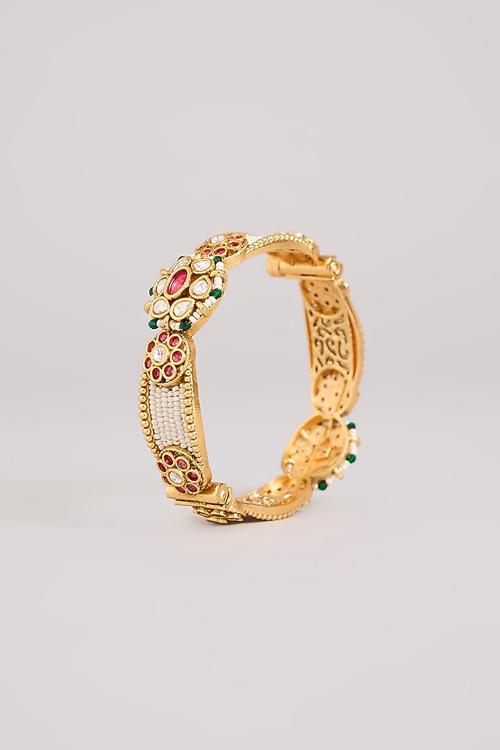 Gold Finish Kundan Polki & Red Stone Bangles (Set Of 2) by Preeti Mohan at Pernia's Pop Up Shop