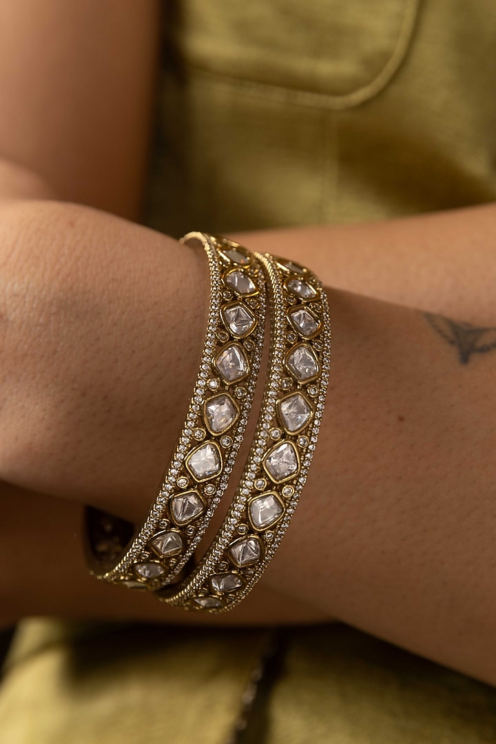 Antique Gold Finish Kundan Polki Bangles (Set Of 2) by Preeti Mohan at Pernia's Pop Up Shop