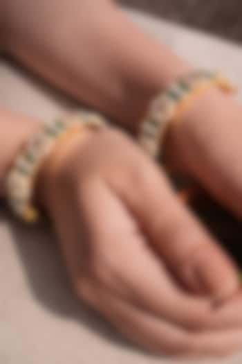 Antique Gold Finish Emerald Temple Bangles (Set Of 2) by Prestones at Pernia's Pop Up Shop