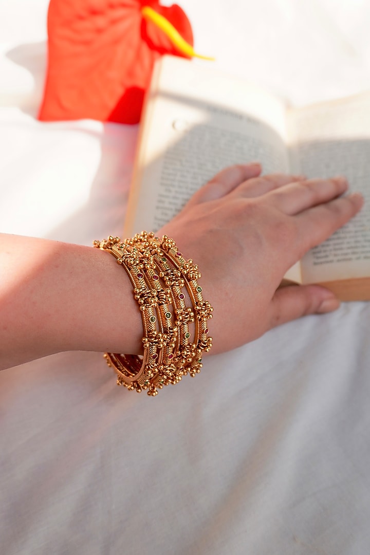 Antique Gold Finish Ghungroo Temple Bangles (Set Of 4) by Prestones at Pernia's Pop Up Shop