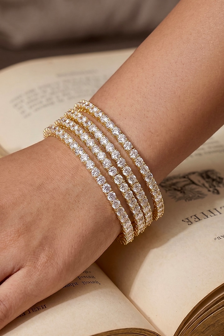 Gold Finish Precision-Set Crystal Bangles (Set Of 4) by Prestones at Pernia's Pop Up Shop