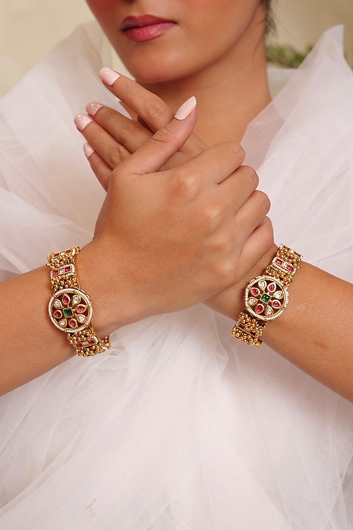 Antique Gold Finish Kundan Polki & Pearl Temple Floral Bangle (Set Of 2) by Prestones at Pernia's Pop Up Shop