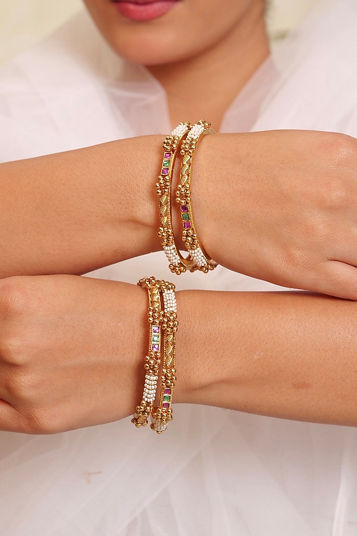 Antique Gold Finish Floral Motifs Textured Temple Bangle (Set Of 4) by Prestones at Pernia's Pop Up Shop