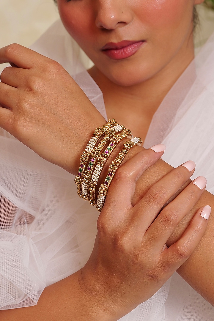 Antique Gold Finish Floral Motifs Textured Temple Bangle (Set Of 4) by Prestones at Pernia's Pop Up Shop