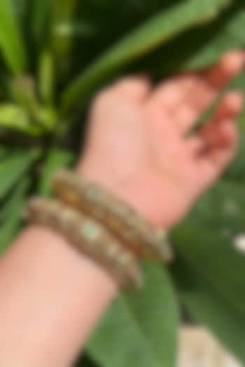 Gold Finish Multi-Colored Stone Carved Temple Bangles (Set Of 2) by Prestones at Pernia's Pop Up Shop