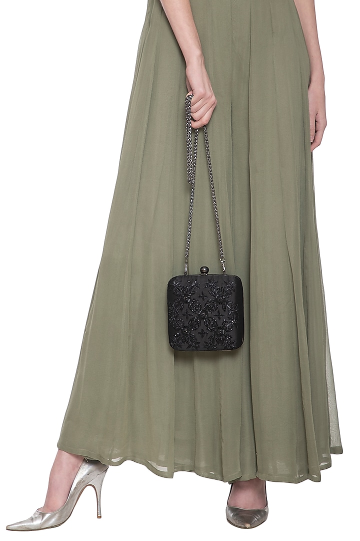 Black embroidered sling clutch bag by PRACCESSORII at Pernia's Pop Up Shop