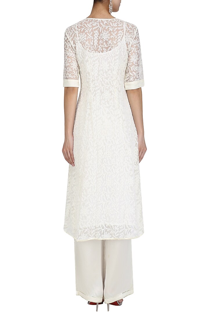 Ivory chikankari kurta set with peach dupatta available only at Pernia's Pop Up Shop.