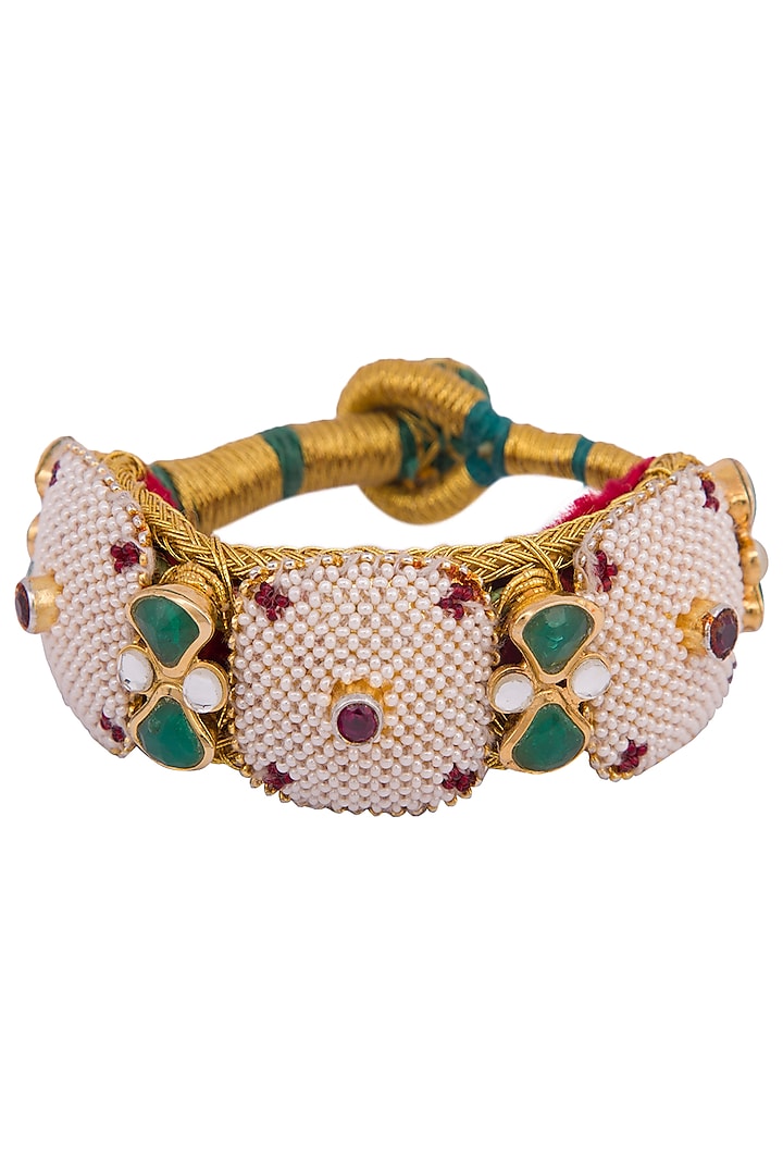Gold plated pearl, stones, zari and kundan pochi bracelet by Parure