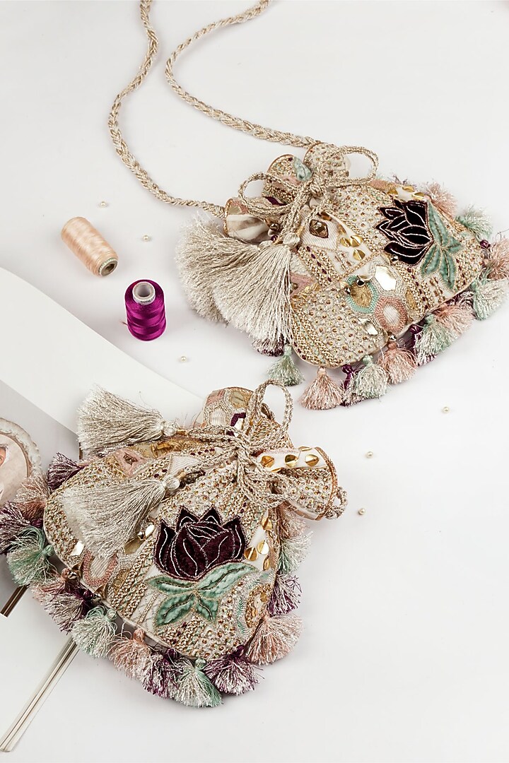 Crem Dupion Silk Hand Embroidered Potli by PAYAL SINGHAL ACCESSORIES at Pernia's Pop Up Shop