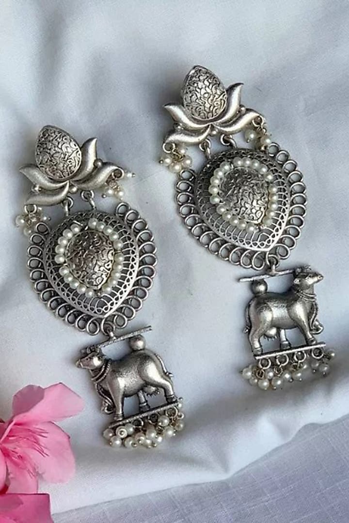 Black Rhodium Finish Cow Motif Temple Earrings by PUTSTYLE at Pernia's Pop Up Shop