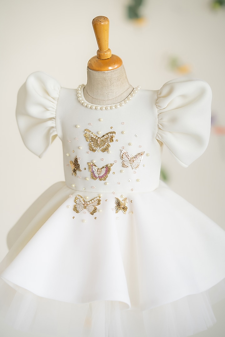 Off-White Scuba & Soft Net Hand Embroidered Flared Dress For Girls by Ruchikalathlabel at Pernia's Pop Up Shop