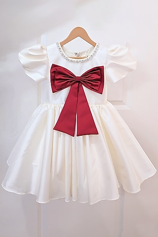 Cream Taffeta Blend Flared Bow Dress For Girls by Ruchikalathlabel