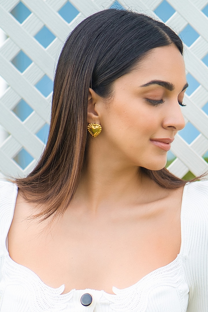 Gold Finish Heart Stud Earrings by Radhika Agrawal Jewels