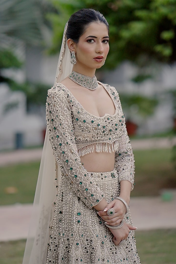 Ivory Net Sequin Embroidered Bridal Bridal Lehenga Set by Ridhi garg at Pernia's Pop Up Shop
