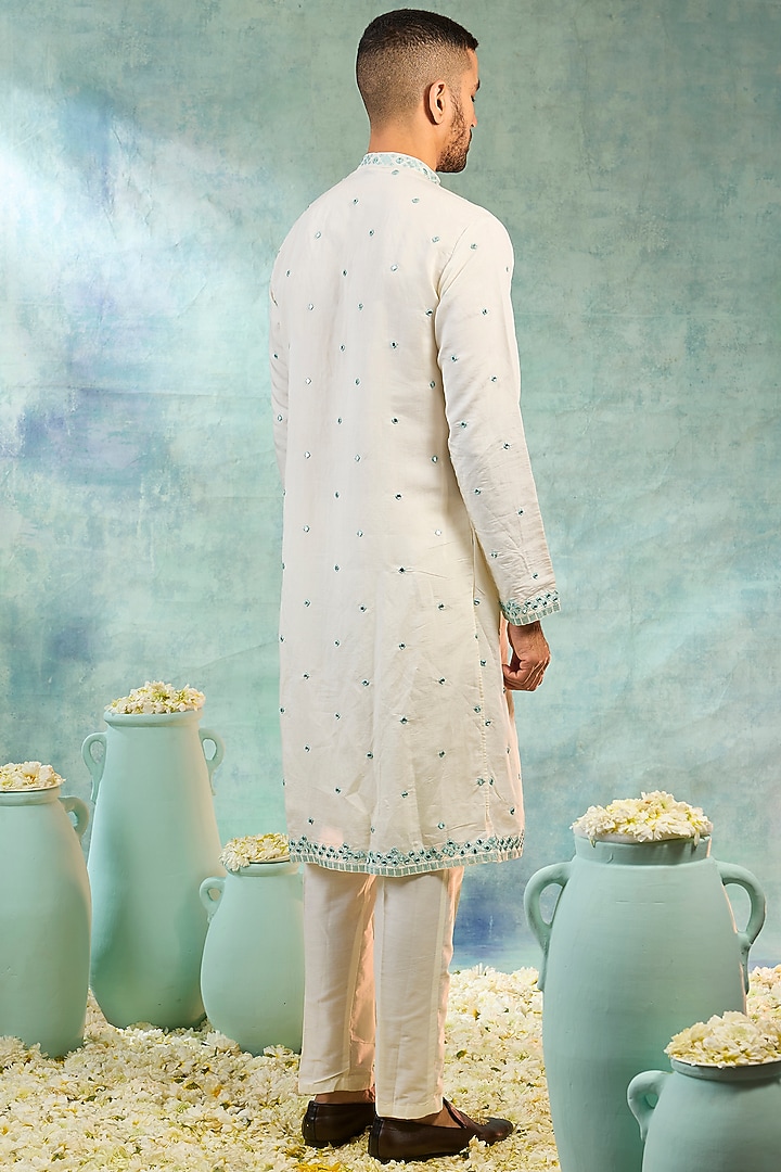 Pearl White Silk Mirror Embellished Koti Set by RIYAASAT at Pernia's Pop Up Shop