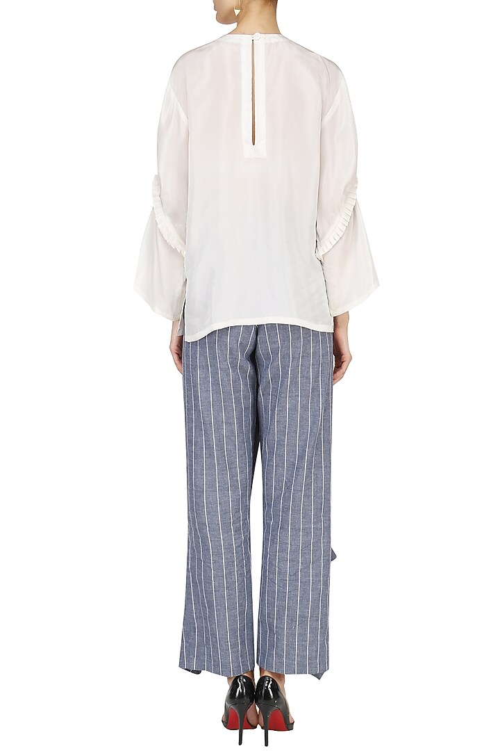 White pin tucked tunic with striped wrap pants available only at Pernia's Pop Up Shop.