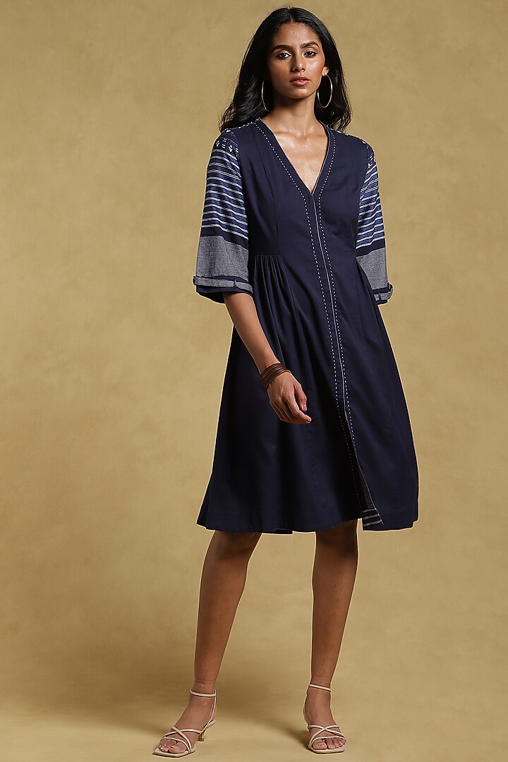 ritu kumar navy blue dress Classic Ritu Kumar motifs adorn the neckline and cuffs on this indigo dress. Shaped like a kaftan, this expanse of chinon flows freely in the breeze. Jewellery by @apalabysumitofficial. #RituKumar #FestiveWinter2025