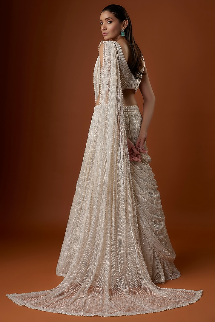 Ivory Crepe & Net Geometric Cutwork Draped Jacket Bridal Lehenga Set by Ritika Mirchandani at Pernia's Pop Up Shop