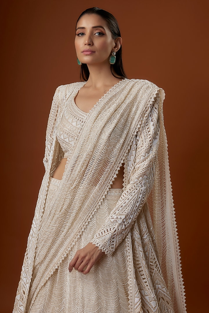 Ivory Crepe & Net Geometric Cutwork Draped Jacket Bridal Lehenga Set by Ritika Mirchandani at Pernia's Pop Up Shop