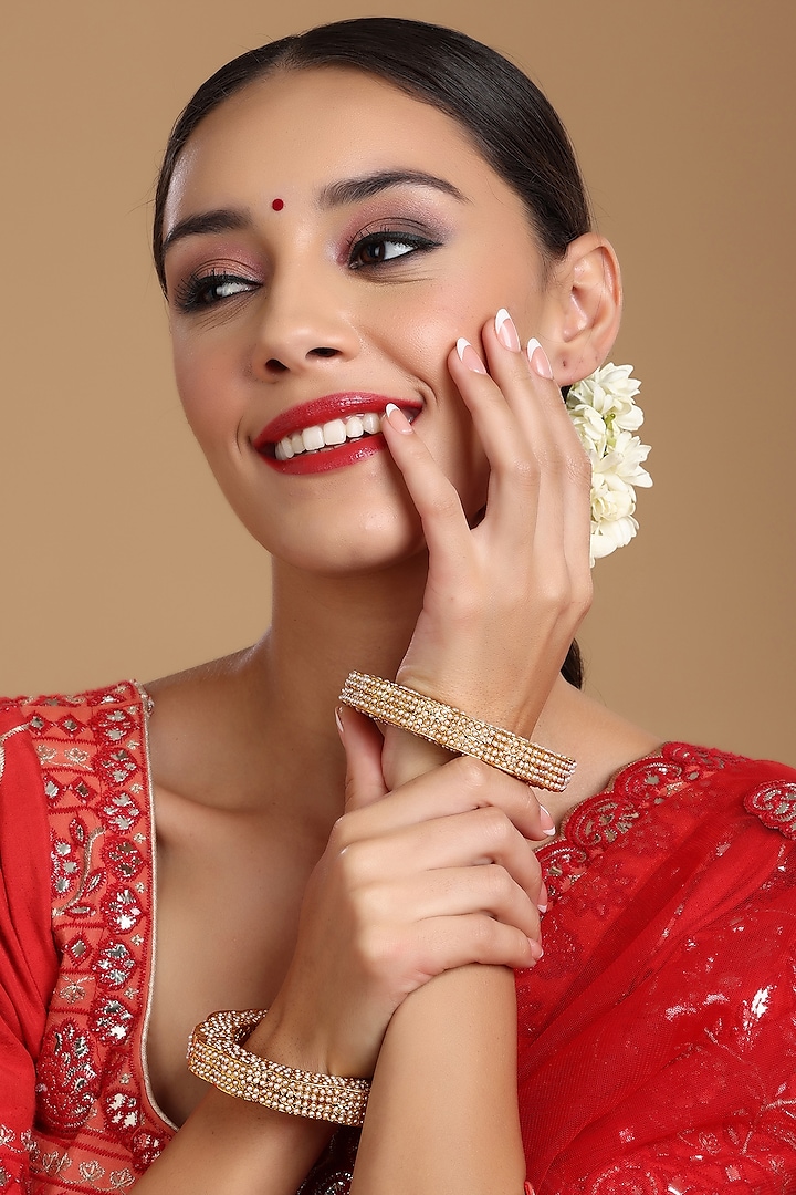 Gold Finish White Kundan Polki Bangles (Set Of 2) by Ruby Raang at Pernia's Pop Up Shop