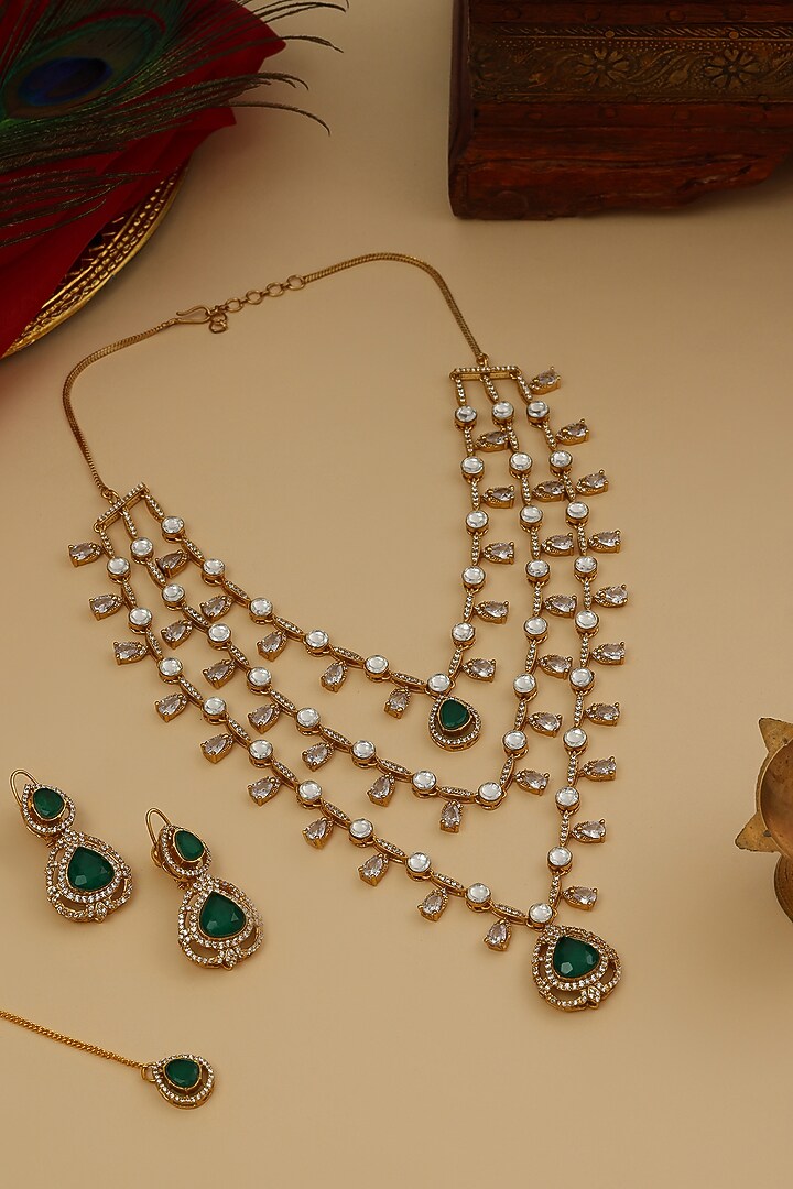 Gold Finish Moissanite & Emerald Stone Layered Necklace Set by Ruby Raang at Pernia's Pop Up Shop